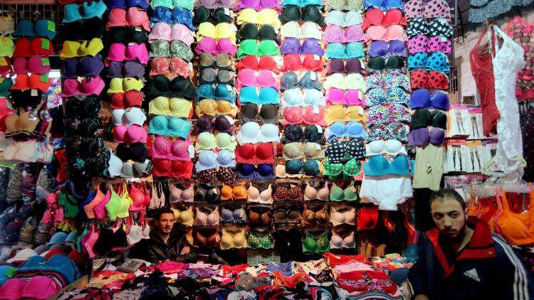 Syrian market traders mind their lingerie stall in Damascus