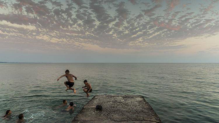 Children jumping into the Black Sea after sunset in Abkhazia