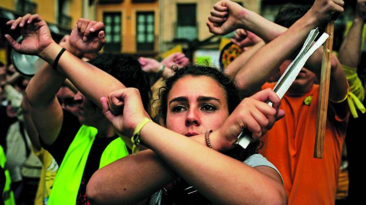 People protest in front of the City Hall of Pamplona, northern Spain. 