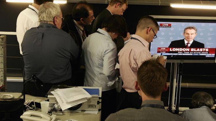 Journalists watch Tony Blair's televised statement after the London 7/7 bombings