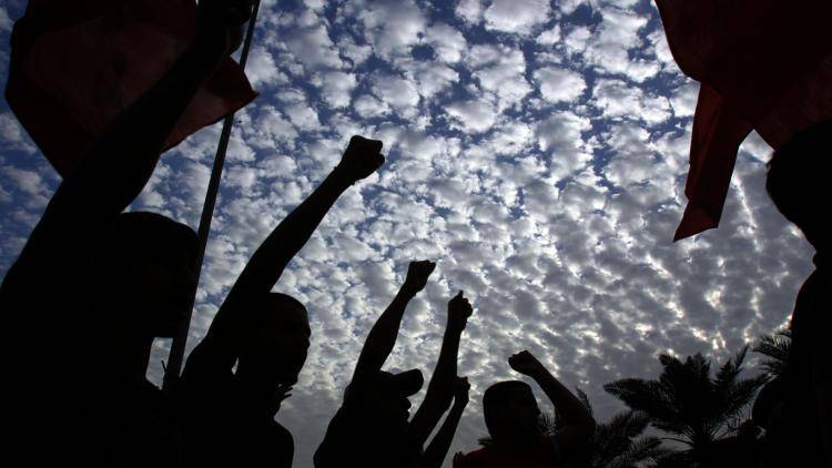 Bahraini men participate in an anti-government protest through the capital of Manama. 
