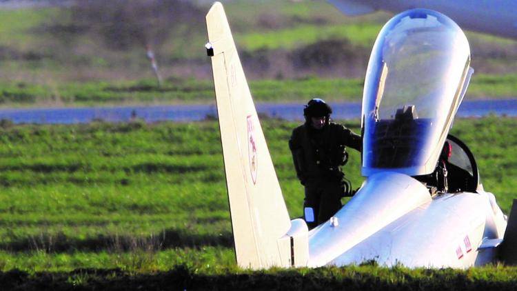 A pilot climbs out of a British Typhoon jet fighter, supporting military action against Libyan leader Colonel Muammar Gaddafi.
