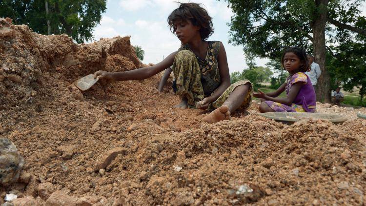 Child labourers collect mica at a scrap mine in the eastern Indian state of Jharkhand