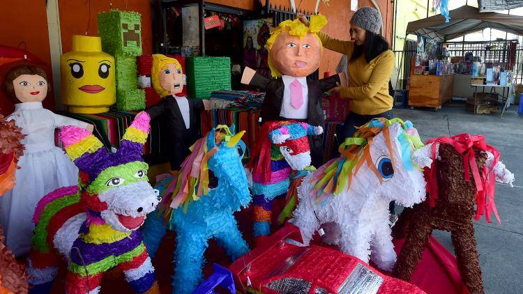 A piňata in the image of US president Donald Trump goes on display on a market stall in Los Angeles