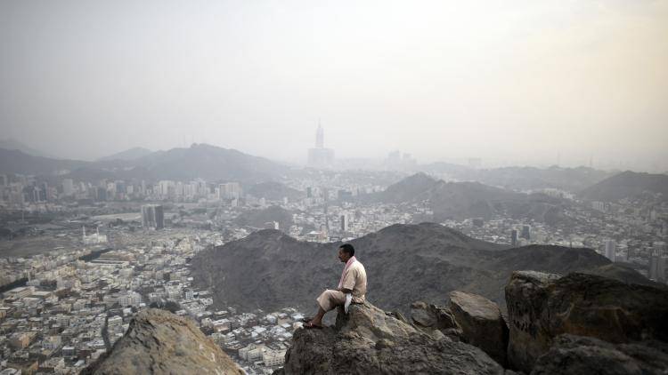 A pilgrim looks at the holy Islamic city of Mecca from the top of Noor mountain