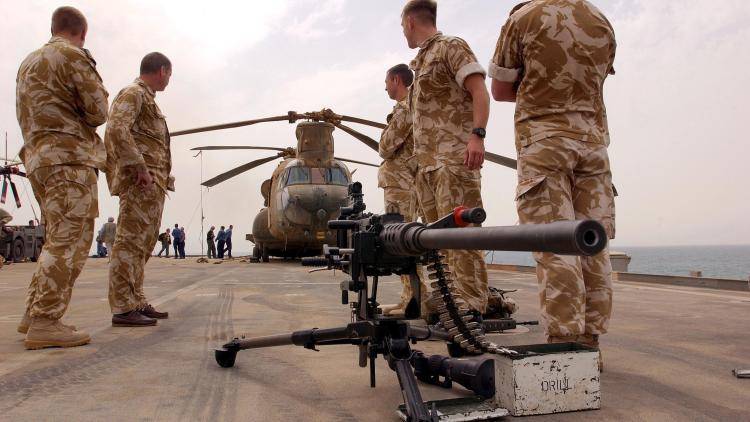  Members of the Royal Marines stand on board the HMS Ark Royal.