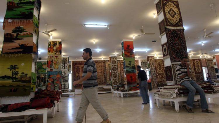 Egyptian salesmen wait for customers at a carpet shop in the tourist site of Saqqara.