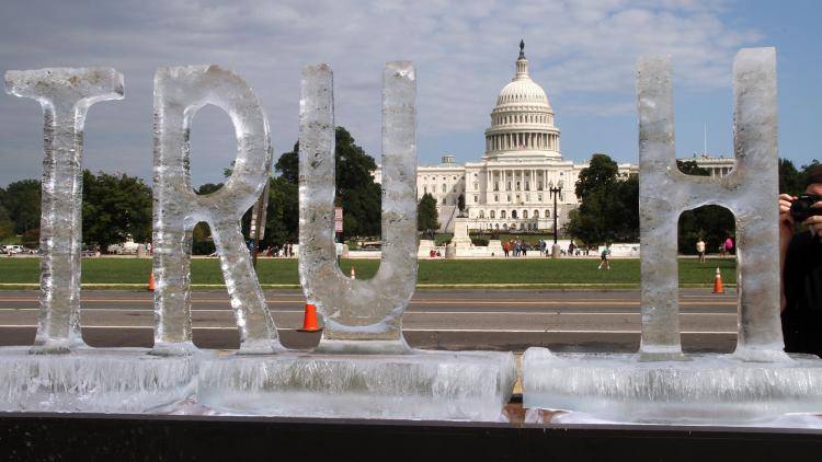 An ice sculpture is seen spelling out the word 'truth'  in Washington, DC in September 2018
