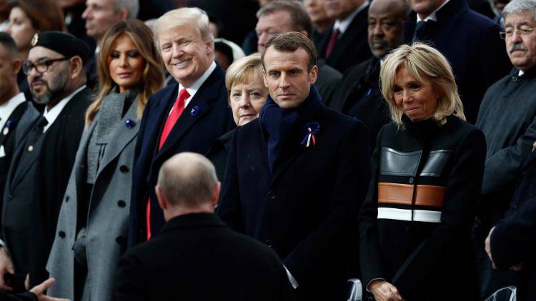 Donald Trump smiles in welcome to Vladimir Putin in Paris 