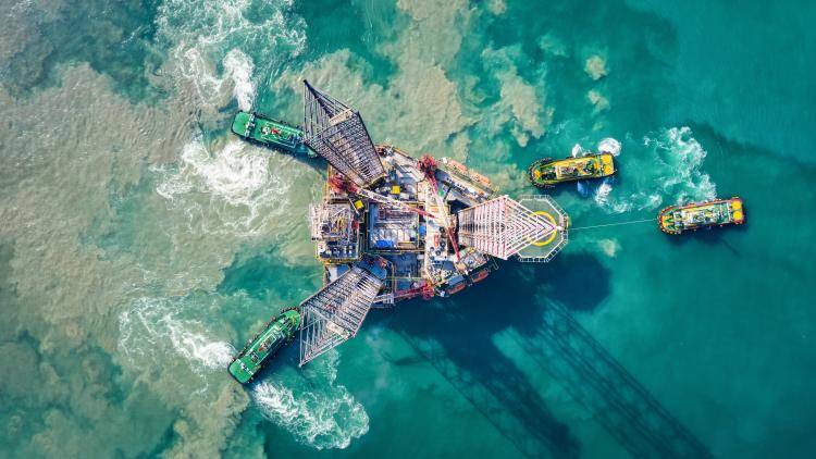 Supply boats towing an oil drilling rig, São Tomé and Príncipe. Photo: Getty Images.