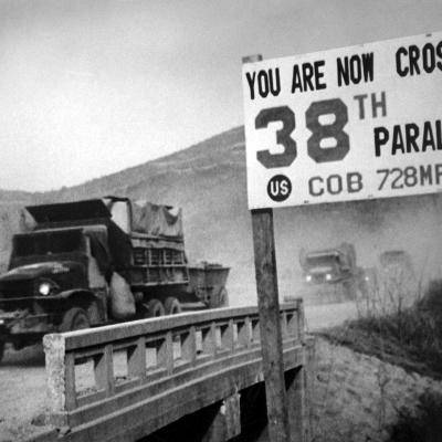 Trucks cross the 38th parallel in Korea during the Korean War