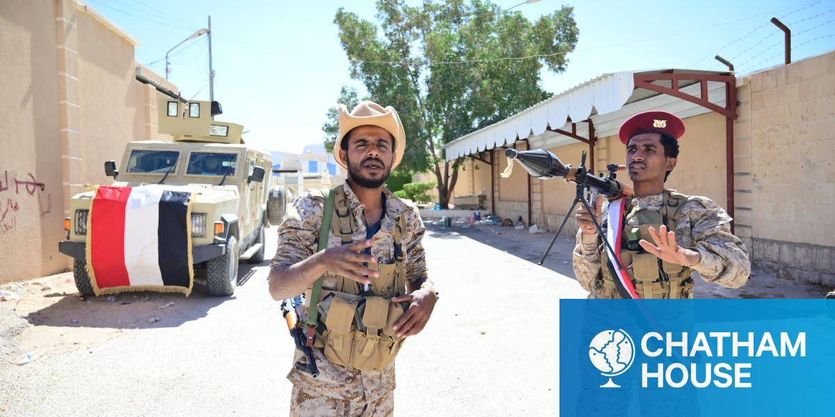 Two members of Yemen's Pro-government Homeland Shield forces, one posing with an RPG