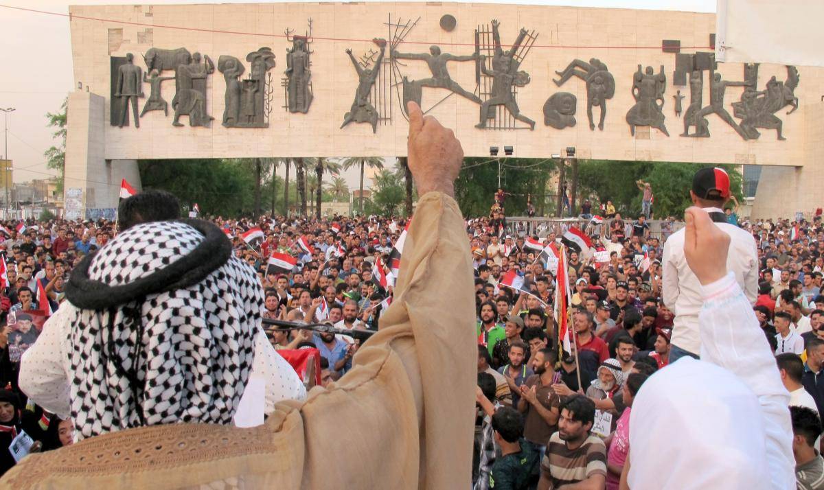 Supporters of Shia cleric Muqtada al-Sadr hold flags and shout slogans during an anti-corruption demonstration in Baghdad, Iraq, on 16 September 2016. Photo: Getty Images.