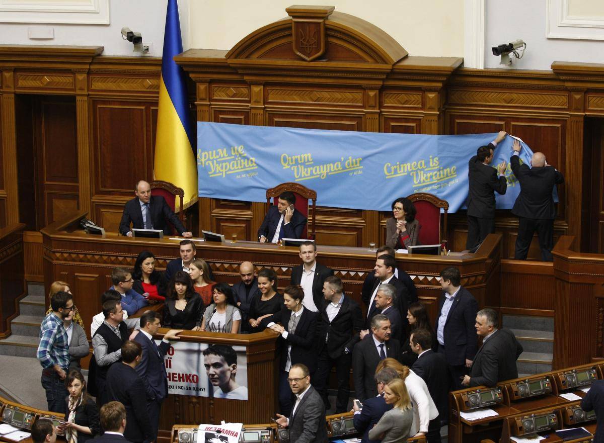 A banner marking the first anniversary of Russia's illegal annexation of Crimea is hung during a plenary session of Ukraine's parliament, the Verkhovna Rada, on 6 March 2015. Photo: Anadolu Agency/Contributor/Getty Images
