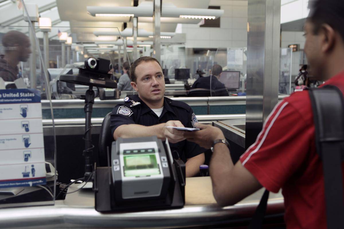 A Customs and Border Protection officer processes an incoming passenger at Newark Liberty International Airport. Photo: US Customs and Border Protection/Flickr.