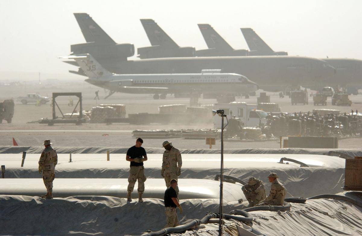 Members of the Petroleum Oils and Lubricants (POL) squadron at the 379th Air Expeditionary Wing take a break from replacing a 50,000-gallon fuel bladder in support of Operation Enduring Freedom December 30, 2002 in Al Udeid, Qatar.