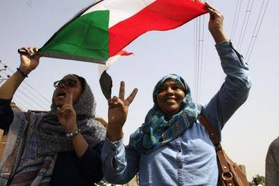 Sudanese demonstrators in Khartoum celebrate a hard-won transitional agreement on 4 August 2019. The agreement provides for a joint civilian-military body to oversee a civilian government and parliament for a three year transition period. Photo: Getty Images.