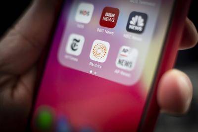 The Reuters and other news apps seen on an iPhone, 29 January 2019. Photo: Getty Images.