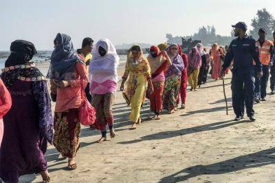 Coast guards escort Rohingya refugees following a boat capsizing accident in Teknaf on 11 February 2020. Photo: Getty Images. 
