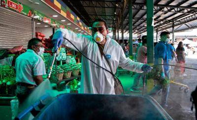A municipal cleaning worker disinfects the central market in Santiago, Chile on 7 April 2020 amid the coronavirus pandemic. Photo: Getty Images.