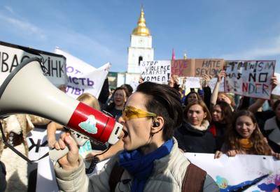A protester chants slogans on a megaphone during an International Women's Day protest on 8 March 2019 in Kyiv, Ukraine. Photo: Getty Images.
