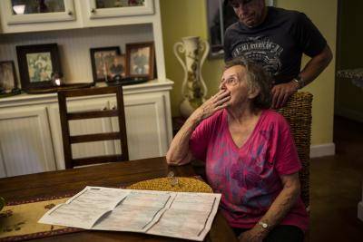 Dee Knapp weeps as she looks over the death certificates of four of her five children as her son, Keylan Knapp, stands over her at home on 14 August 2018 in Luther, Oklahoma. Keylan was the only remaining child of Dee's five children, and he died of a drug overdose at the start of the COVID-19 pandemic in March 2020. All of Dee's five children have passed away. Photo by Lynsey Addario/Getty Images. 