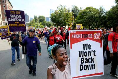 Chefiatou Tokou chants during a Labor Day march in Boston on 4 September 2017. Local cooks and cashiers from McDonald's, Burger King and other restaurants walked off the job,  joining strikes by fast food workers in 300 cities. Photo by Craig F. Walker/The Boston Globe via Getty Images. 