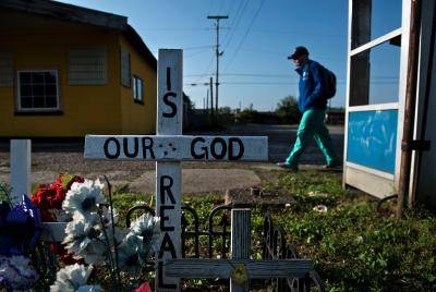 A memorial questions the existence of God in Huntington, West Virginia on 20 April 2017. The city has been portrayed as the epicentre of the opioid crisis. 'This epidemic doesn't discriminate,' Huntington Mayor Steve Williams said. 'Our youngest overdose was 12 years old. The oldest was 77.' Photo by Brendan Smialowski/AFP via Getty Images.