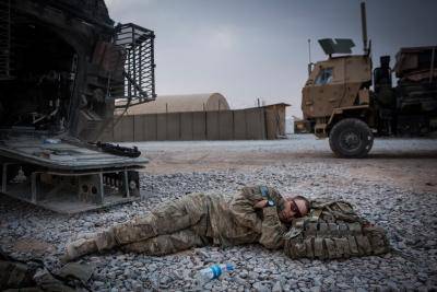 A soldier in the US Army's 1st Battalion, 36th Infantry Regiment, Charlie Company naps during a maintenance stop at Forward Operating Base Azzizulah on 18 March 2013 in Kandahar Province, Maiwand District, Afghanistan. Photo by Andrew Burton/Getty Images.