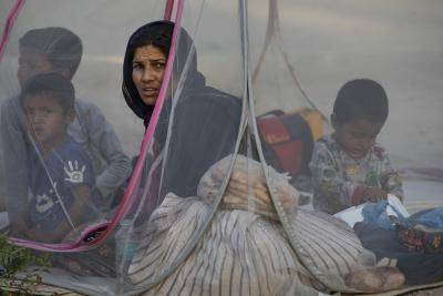 Displaced Afghans sit in a tent at a makeshift IDP camp in Share-e-Naw park to various mosques and schools on 12 August 2021 in Kabul, Afghanistan. People displaced by the Taliban advancing are flooding into the Kabul capital to escape the Taliban takeover of their provinces. Photo by Paula Bronstein/Getty Images.