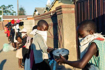 Locals queue outside Samantha Murozoki's home, where she offered free meals during the government imposed coronavirus lockdown in Zimbabwe