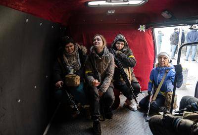 Armed female Ukrainian volunteers in the back of a van on February 25, 2022