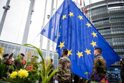 Soldiers of a Eurocorps detachment raise the EU flag at the European Parliament in Strasbourg.