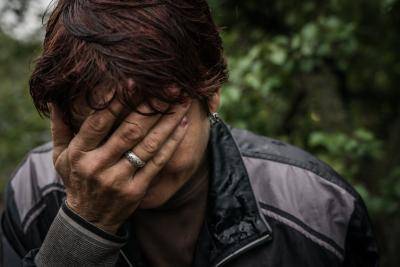 A woman raped by Russian soldiers and hit by shrapnel covers her face with her right hand in Izium, Ukraine, 16 September 2022