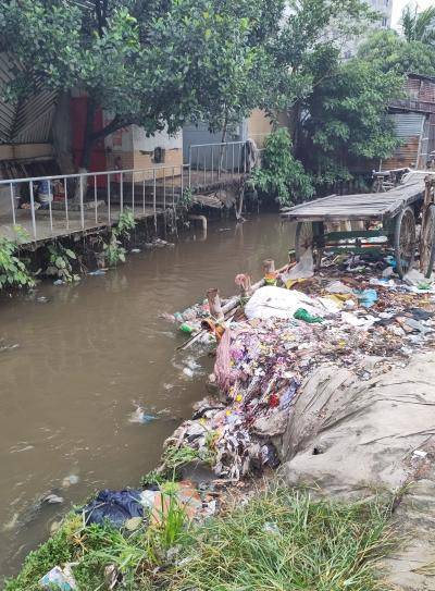 A waterway in Dhaka, Bangladesh, choked with textile waste choking one bank