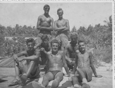 archive black and white photo of a group of young air force officers sitting shirtless outside