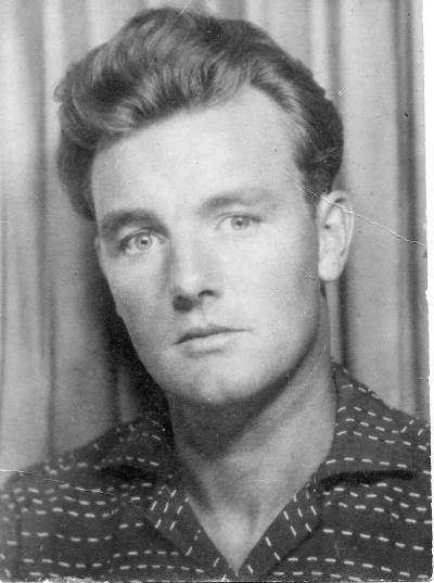 black and white headshot of a young man looking into the camera