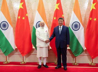 Narendra Modi and Xi Jinping shake hands before flags of their respective countries in Beijing on 31 August 2025