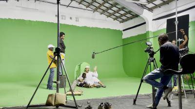 actors in front of a green screen filming a scene from a documentary