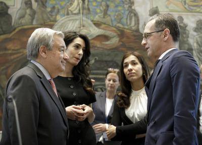 Nadia Murad stands in the UN Security Council with the secretary general and Amal Clooney
