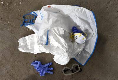 A pile of used protective clothing on the floor at a World Health Organization health training centre to deal with Ebola victims in the Liberian capital Monrovia. Photo by Getty Images.
