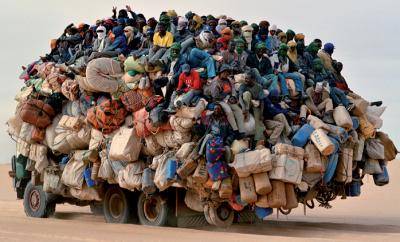 Migrant workers from Libya hitch a ride on a 'cathedral truck'. Photo: Roberto Neumiller/Sos Sahel