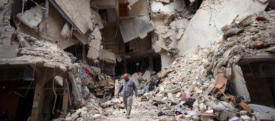 A man walks amid the devastation wrought by the prolonged air bombardment of Aleppo which has killed more than 600 civilians. Photo: Dimitar Dilkoff/AFP/Getty