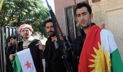 Syrian rebels hold the Kurdish flag, right, and pre-Baath Syrian flag. Photo: Bulent Kilic/AFP/Getty Images