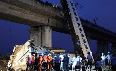 Workers clearing wreckage after a train derailment near Wenzhou. Photo: STR/AFP/Getty Images
