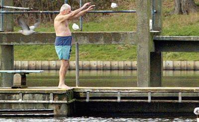 A man prepares to dive into the Men's Bathing Pond on Hampstead Heath. Photo: Jim Watson/AFP/GEtty Images