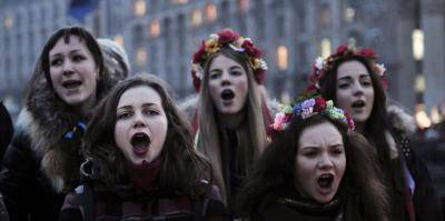 Girls chant the Ukrainian national anthem in Kyiv's Maidan. Photo: Louisa Gouliamaki/AFP/Getty
