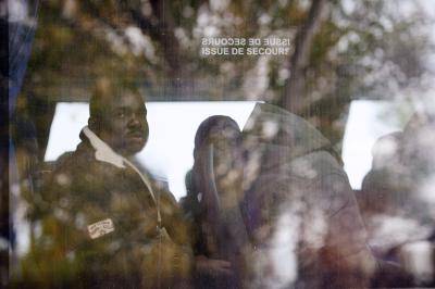 A man sits on a bus as migrants and asylum seekers mostly from Sudan leave the 'Jungle' camp in Calais on 27 October 2015. Photo by Getty Images.