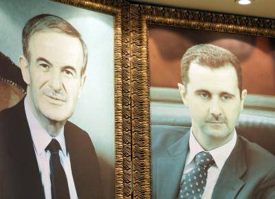 Giant images of Bashar al-Assad and his late father Hafez al-Assad at the Damascus hotel. Photo by Getty Images.