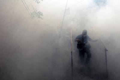 A health ministry employee fumigates against the aedes aegypti mosquito to prevent the spread of the Zika virus in El Salvador, on 21 January 2016. Photo by Getty Images.